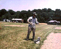 Color photograph of the author using a hand-held 2 or 3 band radiometer.