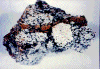 Color photograph example of a specimen of granite from the Sedan nuclear cratering explosion.