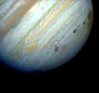 Natural color Hubble image showing impact scars on one side of Jupiter.
